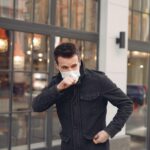 An Unknown Man in a Facemask Coughing